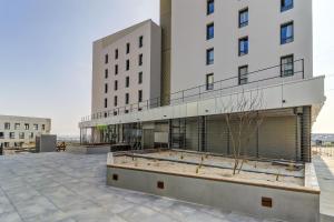 ein Gebäude mit einem Innenhof vor einem Gebäude in der Unterkunft B&B HOTEL Dijon Valmy Toison d'or in Dijon