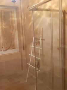 a shower in a bathroom with a glass door at A casa di Adele in Caserta