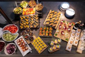 a table topped with lots of different types of food at LUGANODANTE - We like you in Lugano