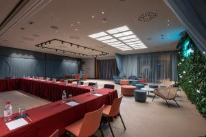 a conference room with tables and chairs and a christmas tree at LUGANODANTE Boutique & Lifestyle Hotel in Lugano