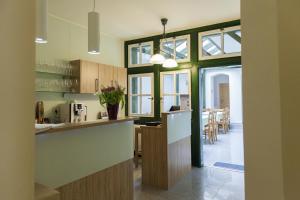 a kitchen with a counter and a dining room at Rezidence Zvon in Znojmo