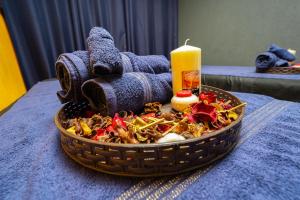 a basket of food with a candle on a table at Le Grand Bleu Hotel in Trou aux Biches +42 photos