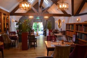 a restaurant with tables and chairs and books at The Nags Head in Montgomery