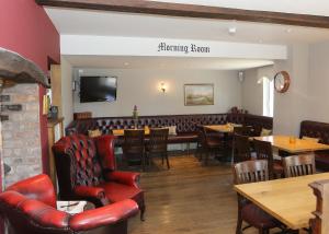 a restaurant with tables and chairs and a bar at The Nags Head in Montgomery