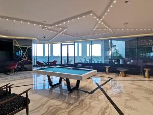 a living room with a pool table in the middle at Vacay Lettings - 1BHK convertible to 2BHK in Business Bay in Dubai