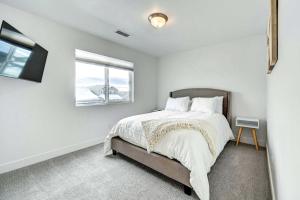 a white bedroom with a bed and a window at Bellemont Getaway about 12 Mi to Flagstaff! in Bellemont