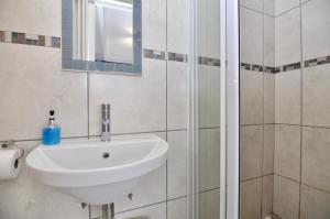 a bathroom with a sink and a shower at La Vue in Mossel Bay