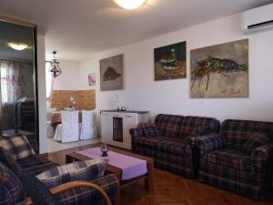 a living room with two couches and a table at Apartment Magdic in Brzac