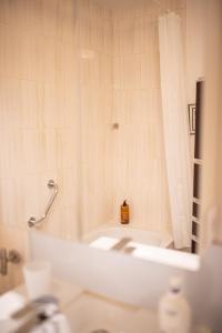 a bathroom with a tub and a sink and a mirror at Appartement deauville place Morny non fumeur in Deauville +31 photos