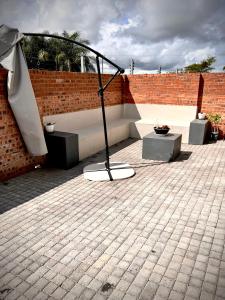 a sculpture on a patio with a brick wall at No Load-Shedding Holiday Home in Mataffin
