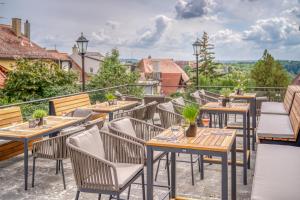 a row of tables and chairs on a patio at Hotel Eisenhut in Rothenburg ob der Tauber