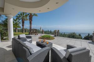 a patio with chairs and a table and a playground at Villa Grosse Sea and Mountains View in Gastourion