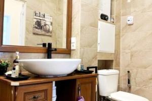 a bathroom with a white sink and a toilet at Lovely 1-bedroom apartment in a historical town in Sillamäe