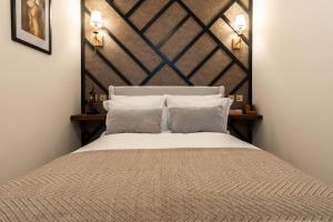 a bedroom with a bed with a large wooden headboard at The Devonshire Suite - Your 5 STAR West End Stay! in Glasgow