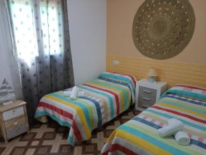 1 dormitorio con 2 camas y ventana en Conjunto Rural Andrea, en Moriles