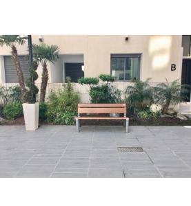a wooden bench sitting in front of a building at Residence miramar in Mohammedia
