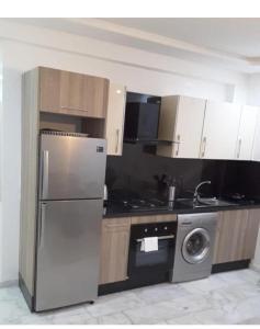a kitchen with a stainless steel refrigerator and a dishwasher at Residence miramar in Mohammedia