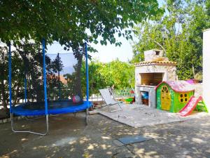 a playground with a play set and a play house at Apartment Magdic in Brzac