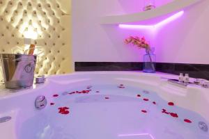 a white bath tub with a vase with flowers in it at Vatican Style in Rome