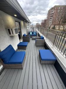 a row of blue chairs on a balcony at Luxury 3Bed Private Apartment Near Manhattan in New Rochelle