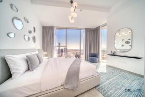 a bedroom with a large bed and a large window at Cosmopolitan 2BR at Stella Maris Dubai Marina by Deluxe Holiday Homes in Dubai