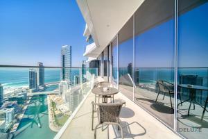 a view of the ocean from the balcony of a building at Cosmopolitan 2BR at Stella Maris Dubai Marina by Deluxe Holiday Homes in Dubai