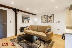 a living room with a couch and a table at Brand New 1 Bed Apt Burton On Tr in Burton upon Trent +3 photos
