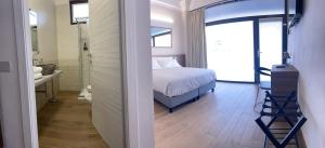 a bedroom with a bed and a bathroom with a shower at Villoresi Rooms in Castano Primo