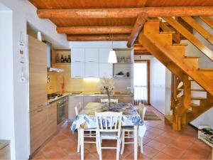 a kitchen with a table and chairs in a room at Lovely holiday home in Valbondione with balcony in Valbondione