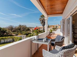a patio with a table and chairs on a balcony at Fantastic four-bedroom villa in Praia da Luz with private pool in Caliços