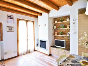 a living room with a television and a table at Lovely holiday home in Valbondione with balcony in Valbondione