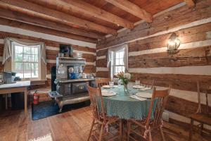 a dining room with a table and a stove at Cabin Vacation Rental about 8 Mi to Penn State! in State College