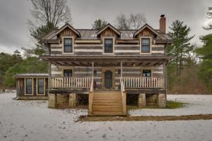 a large wooden house with a porch in the snow at Cabin Vacation Rental about 8 Mi to Penn State! in State College