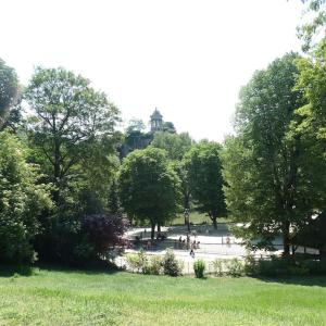 a park with trees and people in a park at Love Nest In Paris in Paris