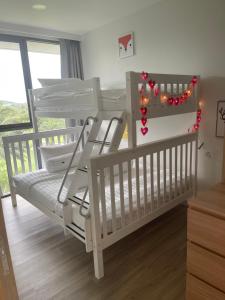 a nursery with two bunk beds and christmas lights at Laguna SkyPark вид на горы и озера три 25 метровых бассейна на крыше, 500 Мбит интернет, все апартаменты верхние 6 и 7 этажи in Bang Tao Beach