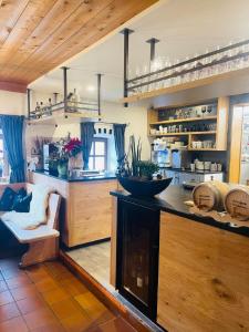 a large kitchen with a counter and a counter top at Almberghütte in Philippsreut