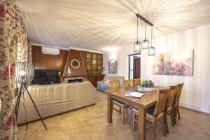 a living room with a table and a couch at Villa El Mal Pas / Can Seguinet in Alcudia