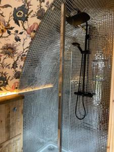 a shower with a mesh wall in a bathroom at Doxford Farm Camping in Alnwick