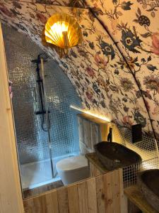 a bathroom with a shower and a sink and a tub at Doxford Farm Camping in Alnwick