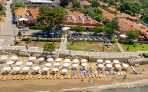 an aerial view of a beach with tables and umbrellas at Clover Magic Nova Beach Hotel in Side