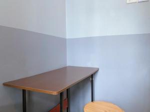 a wooden table in a room with a wooden chair at K Hotel 14 in Singapore
