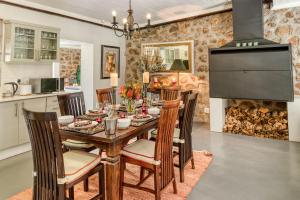 a dining room with a table and chairs and a fireplace at Trout Escape Farm in Dullstroom