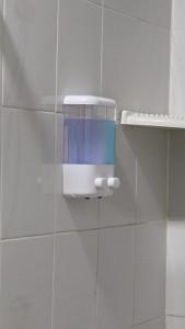 a soap dispenser on the wall of a bathroom at Jurockotel in Pattaya Central
