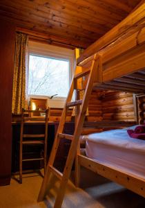 a bedroom with two bunk beds and a desk at Pabay in Duirinish