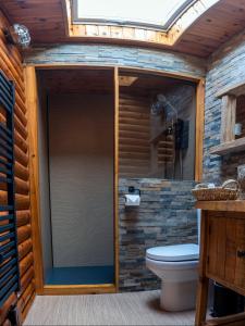 a glass shower in a bathroom with a toilet at Pabay in Duirinish