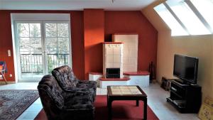 - un salon avec un canapé et une télévision dans l'établissement Apartment-Sonnenparadies-Wandlitz, à Wandlitz