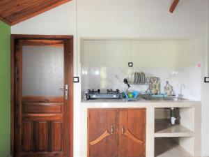 a kitchen with a sink and a wooden door at hotel trecicogne in Morondava +44 photos