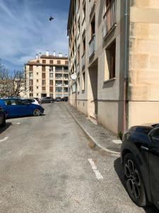 a car parked in a parking lot next to a building at APPARTEMENT OR in Manosque