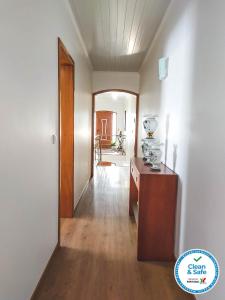 a hallway with a wooden table in a room at Alves Nature Rooms in Arrifes
