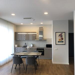 a kitchen and dining room with a table and chairs at Apartamentai Fortuna in Kaunas +46 photos